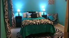 a bedroom with blue walls and zebra print bedding