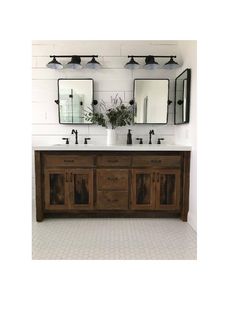 a bathroom with two sinks and mirrors on the wall