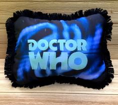 a black and blue pillow with the words doctor who on it