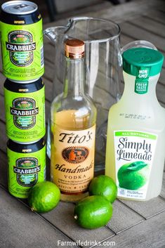 limes, ginger syrup, and other condiments sit on a wooden table