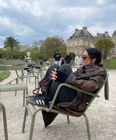 a woman sitting in a chair with her legs crossed