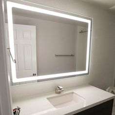 a bathroom with a sink, mirror and toilet