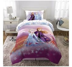 a bed with two frozen princesses on it and snowflakes in the background