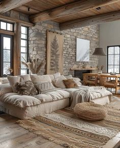 a living room filled with lots of furniture next to a brick wall covered in windows