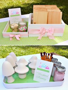 a table with jars, candles and cards on it in the shape of mushroomes