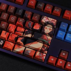 a close up of a keyboard with an anime character on the key board and red keys