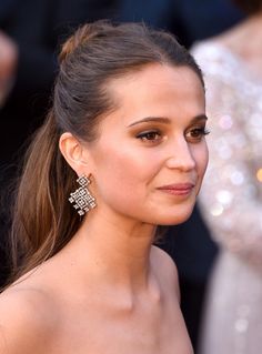 a close up of a person wearing earrings