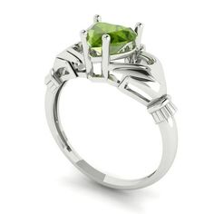 a white gold ring with an oval cut peridot stone in the center and two baguetts on each side