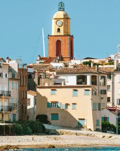 an old building with a clock tower in the middle of it's rooftops