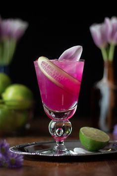 a purple drink in a glass on a table