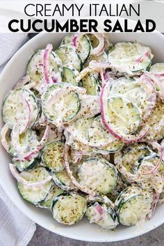 a white bowl filled with cucumber salad on top of a table