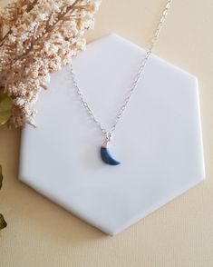 There has always been something magical about the Moon. Add a celestial touch to any outfit with this Blue Moon Pendant Necklace.A dainty natural Blue Opal Crescent Moon is displayed from your choice of Sterling Silver or 14k Gold Filled chain. Both finishes are not plated, lead and nickel free and safe for everyday wear.Blue Opal is associated with the throat chakra, it is believed to be the stone of courage and ingenuity. Soothing light blue gemstone, it is regarded as a strong healing stone t Blue Moon Charm Necklaces For Gifts, Blue Moon Charm Necklace Gift, Blue Moon Charm Necklace For Gift, Blue Moon Charm Pendant Necklace, Adjustable Blue Moon-shaped Jewelry, Blue Celestial Necklace With Moon Charm, Blue Moon Phase Round Pendant Necklace, Blue Moon Charm Necklace For Jewelry Making, Blue Moon Phase Necklace For Gift