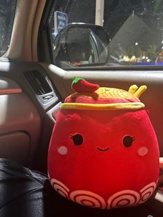 a stuffed toy sitting in the front seat of a car