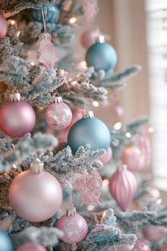 a decorated christmas tree with pink and blue ornaments