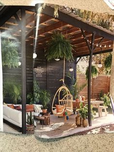 an outdoor living area with potted plants and furniture