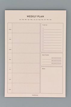 the weekly planner is shown on top of a gray surface with numbers and lines in it