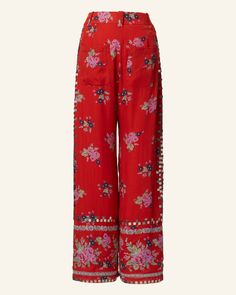 Hand-embellished with metal coins, our red floral print pant has a straight-leg silhouette zip fly closure. Crafted in Tencel, a soft natural fiber, the lightweight ankle pant has a beautiful drape. This one-of-a-kind textile was embroidered by hand. Subtle variations are part of the unique beauty of the garment and a signature of the artisan's hand. Print Pant, Floral Print Pants, Red Floral Print, Unique Beauty, Beautiful Drapes, Soft Natural, Printed Pants, Ankle Pants, Red Floral