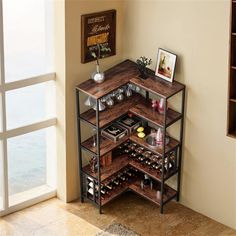 a wine rack with many bottles and glasses on it in front of a window overlooking the ocean