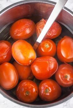 a pot filled with lots of ripe tomatoes