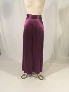 "vintage 1930s palazzo pants beach pajama style popular of the era solid purple silk feel TALON metal side zipper high waist 2\" wide waist band hook eye closure above zipper good vintage condition w/light age wear- some tiny holes, fabric scuffs/marks (nothing major) see photos measures, lying flat, waist-13\" rise-19\" hip-20\" inseam-25\" hem-30\" outseam-42\"     We do not offer returns or refunds unless something is grossly misrepresented. Please contact us within 2 business days of receiving to discuss any possible returns for this reason. We do not offer refunds for your shipping fees. Please feel free to contact us with any questions you may have about an item prior to purchase and we will gladly answer them." Elegant Purple Satin Bottoms, Formal Full-length Purple Bottoms, Purple Formal Full-length Bottoms, Full Length Purple Formal Bottoms, Purple Full Length Formal Bottoms, Elegant Full-length Purple Bottoms, Elegant Full Length Purple Bottoms, Purple Summer Evening Bottoms, Fitted Silk Bottoms With Elastic Waistband