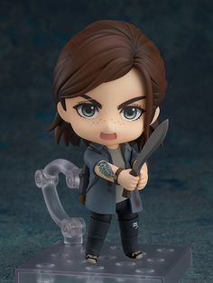 the action figure is holding a knife and looking at something in front of her face