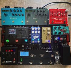 many different types of pedals and amps sitting on top of eachother