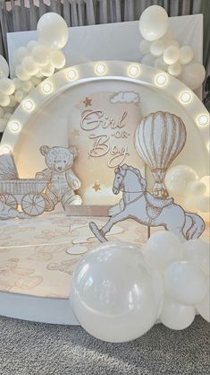 balloons and lights are set up for a baby's first birthday