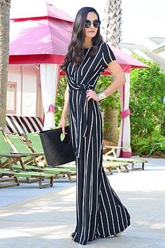 The most flattering jumpsuit around! With elongating vertical stripes and an adjustable side tie, this jumpsuit has an instantly chic and flattering look. Fabric is a stretchy, opaque rayon-blend. Chic Jumpsuits And Rompers With Tie Waist Maxi Length, Chic Striped Jumpsuits And Rompers For Beach, Chic Fitted Jumpsuits And Rompers With Vertical Stripes, Fitted Jumpsuits And Rompers With Vertical Stripes, Spring Forward, Blue Door, Vertical Stripes, Women Clothes, Boutique Clothing