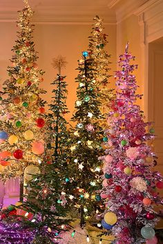 three christmas trees in different colors and sizes