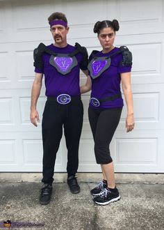 a man and woman in costume standing next to each other near a garage door with their hands on their hipss