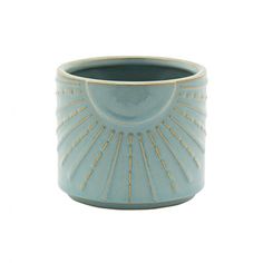 a blue vase with gold trimmings on the outside and inside, sitting in front of a white background