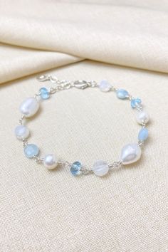 This beaded bracelet is a beautiful mix of sky blue semi-precious gemstones paired with rainbow moonstone and freshwater pearls, artfully designed and handcrafted in bright sterling silver for a timeless, graceful look. Bracelet length:  7 inches plus 1 inch extender MATERIALS ~ Sterling silver ~ Sky blue topaz ~ Aquamarine ~ Rainbow moonstone ~ Cultured freshwater pearls GIFTING ~ Jewelry gift box included. ~ I am happy to ship directly to the recipient.  Enter their address during checkout. ~ Topaz Bracelet, Rainbow Topaz, Blue Topaz Bracelet, Blue Beaded Bracelets, Artfully Designed, Silver Jewelry Necklace, Sky Blue Topaz, Message Jewelry, Blue Jewelry