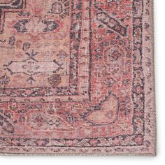 an old rug with faded colors and patterns on the bottom, is shown in pink