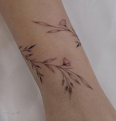 a woman's foot with a flower tattoo on it