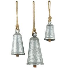 three metal bells hanging from rope on white background