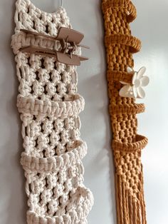 two pieces of crochet hanging on the wall next to each other with scissors