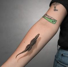 a lizard tattoo on the left arm