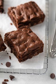 three pieces of chocolate brownie on a cooling rack