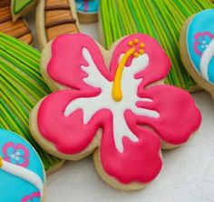 decorated cookies with flowers and leaves are on the table next to each other in different colors