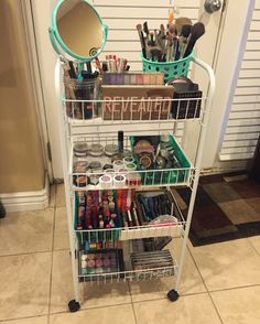 a three tiered cart filled with cosmetics and makeup products