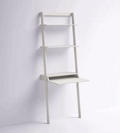 a white ladder leaning against a wall with a shelf on it's side next to the floor