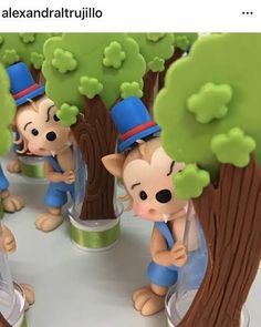 there are many small figurines that look like they are playing in the trees