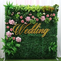 the wedding sign is surrounded by flowers and greenery