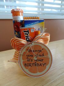 an orange birthday gift basket with candy and candies