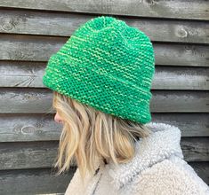 a woman wearing a green knitted hat