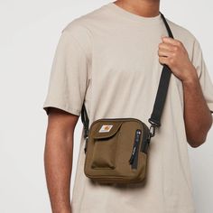 Carhartt Essentials bag.Olive shell.97% recycled polyester, 3% polyurethane.Adjustable strap, front pocket, logo plaque.Zip closure Carhartt Sling Bag, Carhartt Essentials Bag, Olive Shell, Cross Bags, Wip Bag, Shell Bag, Cream Bags, Gifts For Teen Boys, Tan Bag