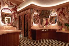 a fancy bathroom with marble counter tops and checkered flooring