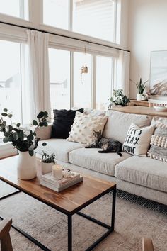 a living room filled with lots of furniture and decor on top of a wooden table