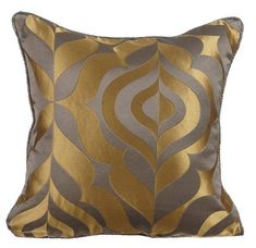 a gold and grey pillow with an abstract design