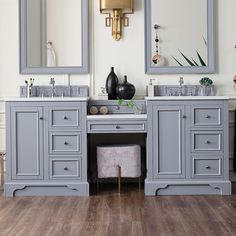 a bathroom with two sinks and mirrors on the wall